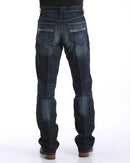 Men's Carter Dark Wash jeans back view showing detail of back pockets, belt loop placement, relaxed fit in seat and leg, boot cut stack on boots.