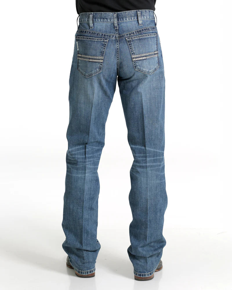 Men's White Label Medium Wash jeans back view showing detail of back pockets, belt loop placement, fit on seat and leg, stack on boots.
