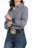 Full left front view of women's blue and fuschia printed Cinch shirt showing spread collar, light blue buttons, left chest small open pocket with fuschia embroidered logo, tailored fit details, 2 button cuff with contrast cuff and collar lining. 