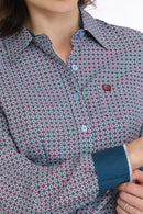 Closeup front view of women's blue and fuschia printed Cinch shirt showing spread collar, light blue buttons, left chest small open pocket with fuschia embroidered logo, tailored fit details, contrast cuff and collar lining. 