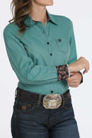 Women's Cinch long sleeve striped teal shirt with showing teal buttons, small left chest pocket with teal logo embroidery, and contrast fabric lining collar and cuffs. Front view.