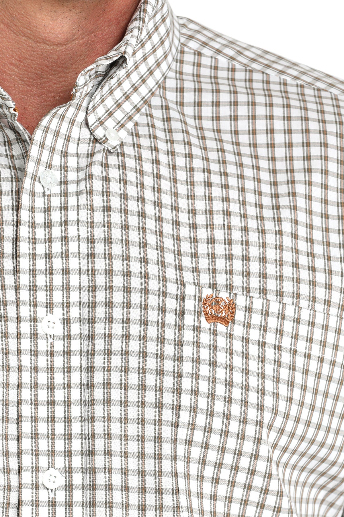 Close-up of a tan plaid shirt with a tan embroidered logo (left chest) on a white background, white front buttons, and button down collar.