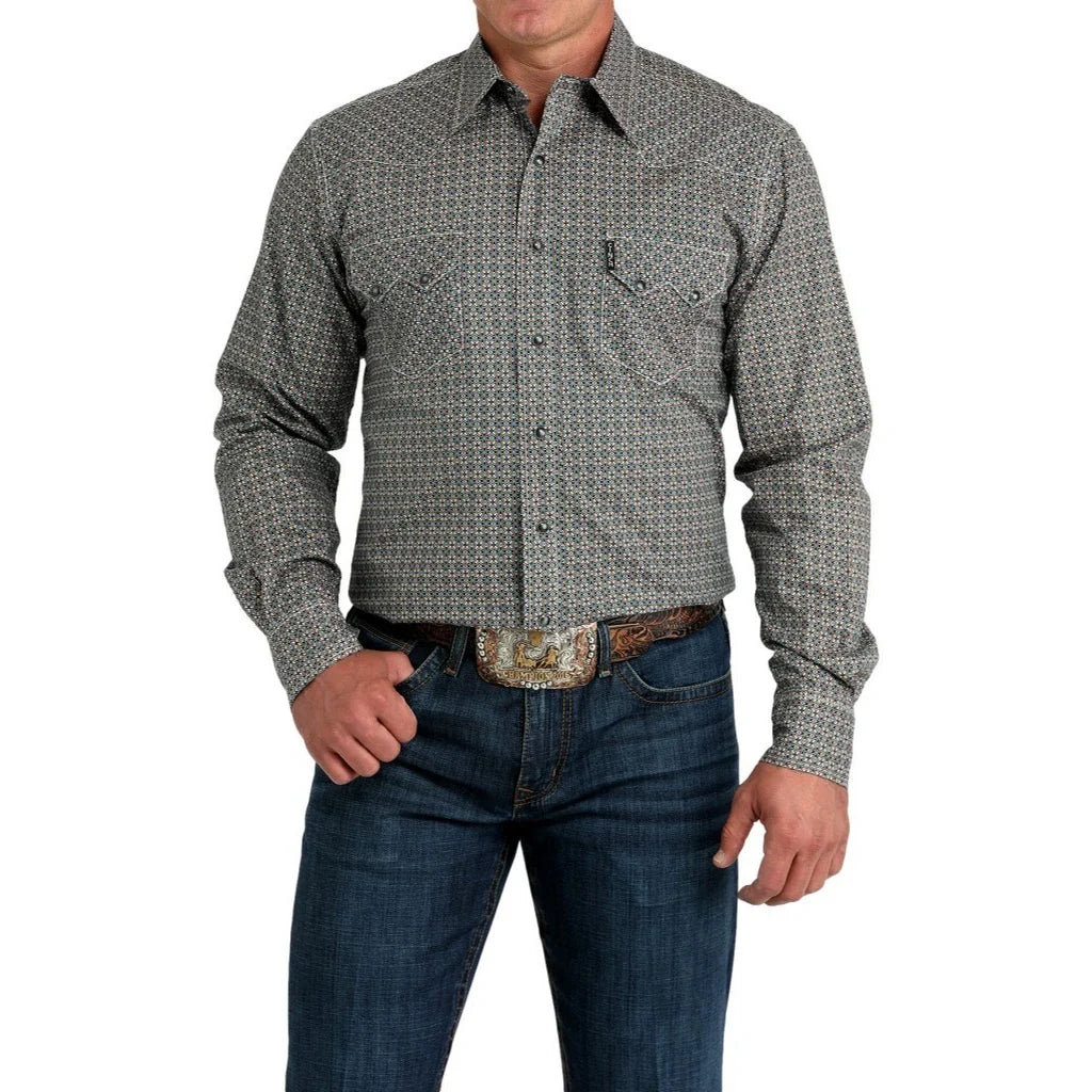 Man wearing a Cinch gray print  long sleeve snap shirt with jeans, a belt, and a belt buckle. Front view.