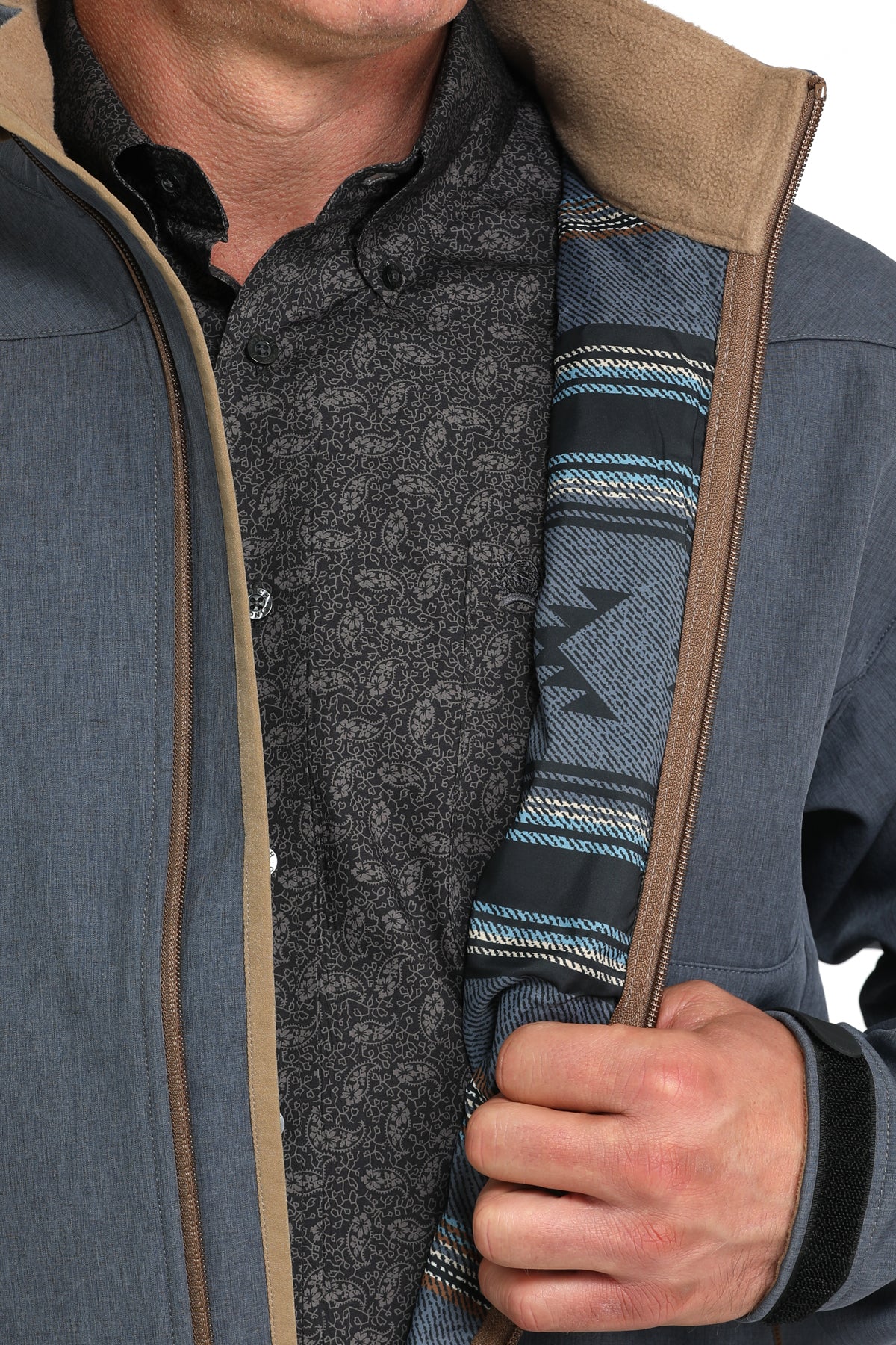 Unzipped front view of Cinch blue bonded jacket that has blue and black aztec striped lining and tan soft velour standing collar lining. Full front zipper shown with blue and tan lining.