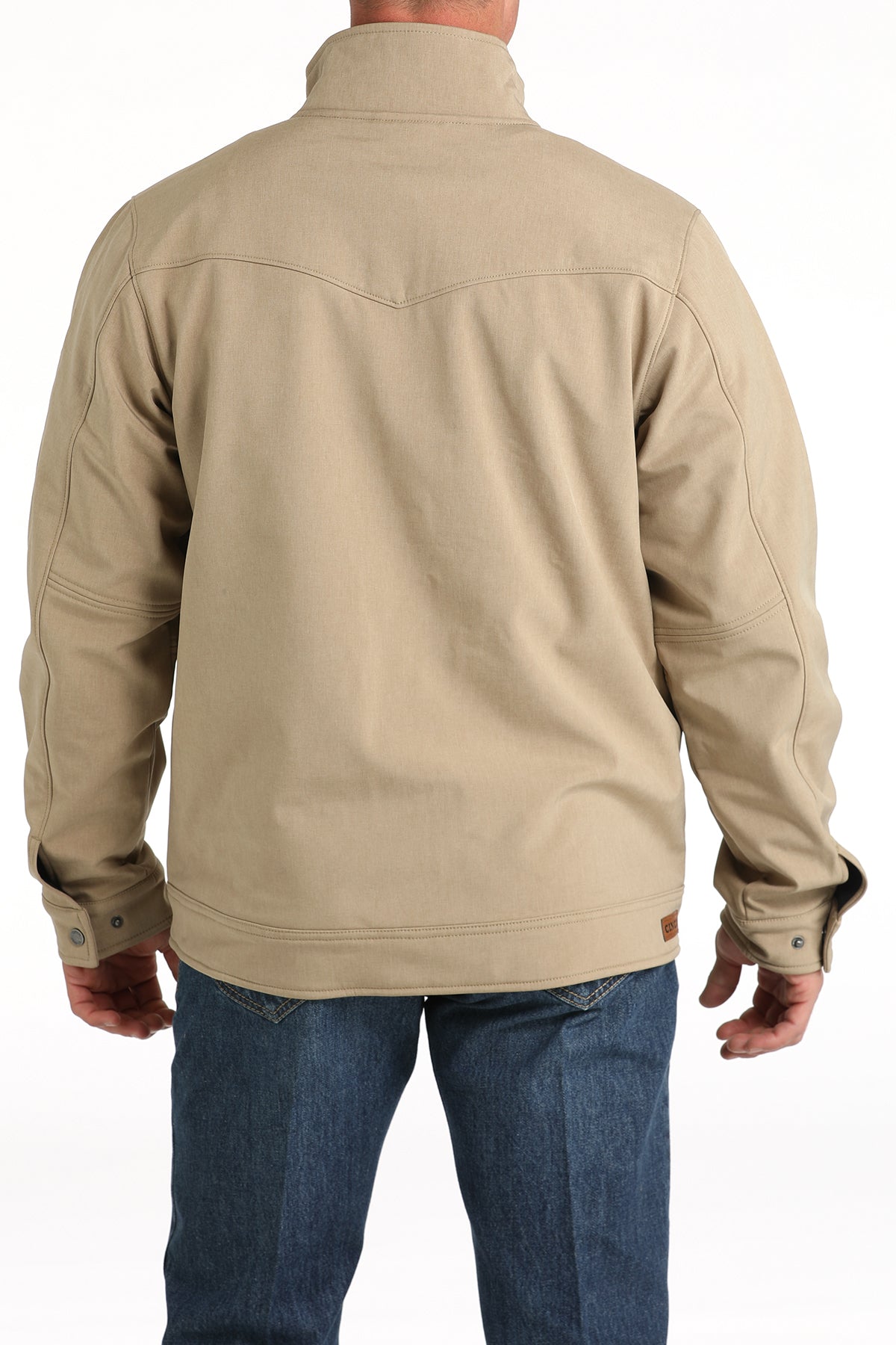 Cinch khaki conceal carry jacket. Has adjustable standing collar, snap cuffs, leather Cinch patch on right side of waist . Fits below waist. Back view.