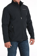 Cinch black solid nylon-spandex ripstop jacket. Has standing collar with soft lining, full front zipper with lining, zippered slash hand pockets, and Cinch block logo embroidered on left chest. Hemmed cuffs and bottom band. Hits low hip. Front right view.