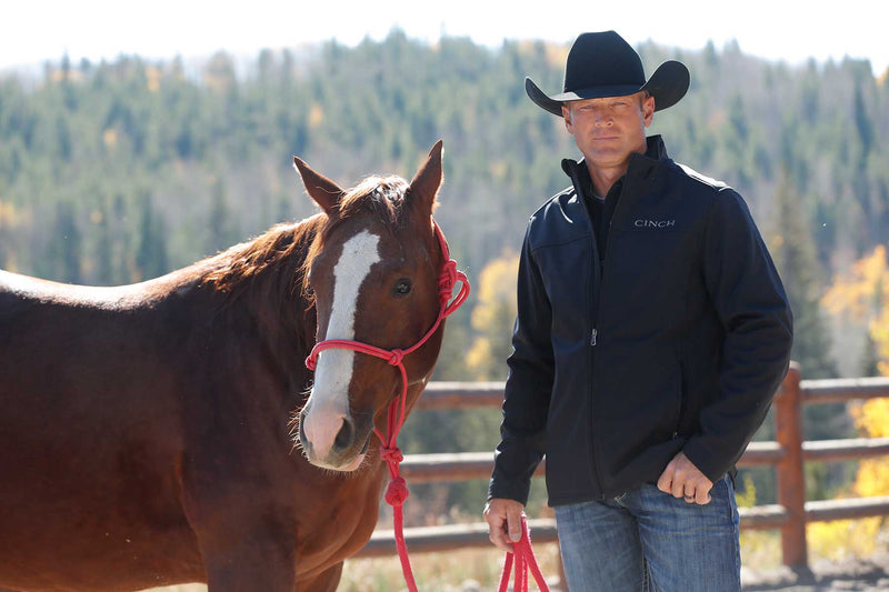 Lifestyle photo of Cinch black nylon-spandex ripstop jacket. Front view.