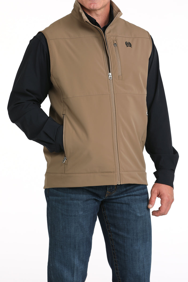 Cinch khaki nylon-spandex ripstop windproof vest. Has full front zipper with lining, slash zippered hand pockets, left chest vertical zippered phone pocket, and black embroidered logo. Hits low hip. Front right view.