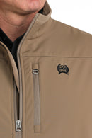 Closeup of left chest showing wind-stopper lined front zipper, vertical zippered phone pocket, embroidered black logo, and velour lined standing collar.