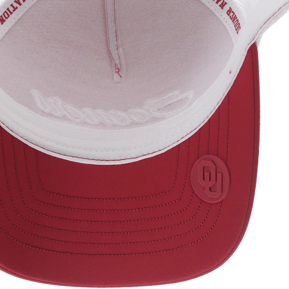 Crimson and white Snapback cap with Sooners embroidered on front with a white mesh back and Hooey logo embroidered on side. Inside view showing OU seal on bill. 