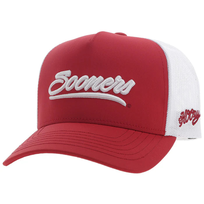 Crimson and white Snapback cap with Sooners embroidered on front with a white mesh back and Hooey logo embroidered on side. Front view stock photo.  