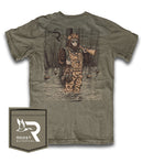 A Roost Branded green short-sleeved pocket t-shirt with a graphic print of Sasquatch holding a duck and a shotgun in a swampy wooden environment. The front left chest of the shirt has the Roost logo on the pocket. 