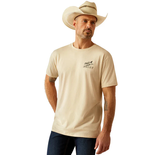 Men's Ariat short sleeve graphic tee in Natural. Front view showing shirt untucked and Ariat logo graphic on left chest. 