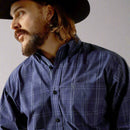 Men's Ariat long sleeve classic fit shirt in Navy.  Close up of chest pocket showing Ariat shield logo. 