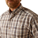 Men's Ariat Pro Series long sleeve shirt in Brown Plaid. Close up of collar and Ariat shield logo on chest pocket. 