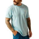 Men's Ariat short sleeve t-shirt in Sky Blue Heather. This shirt has a Southwestern style Ariat logo graphic print. Front view showing shirt untucked.