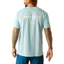 Men's Ariat short sleeve t-shirt in Sky Blue Heather. This shirt has a Southwestern style Ariat logo graphic print. Rear view showing shirt untucked. 