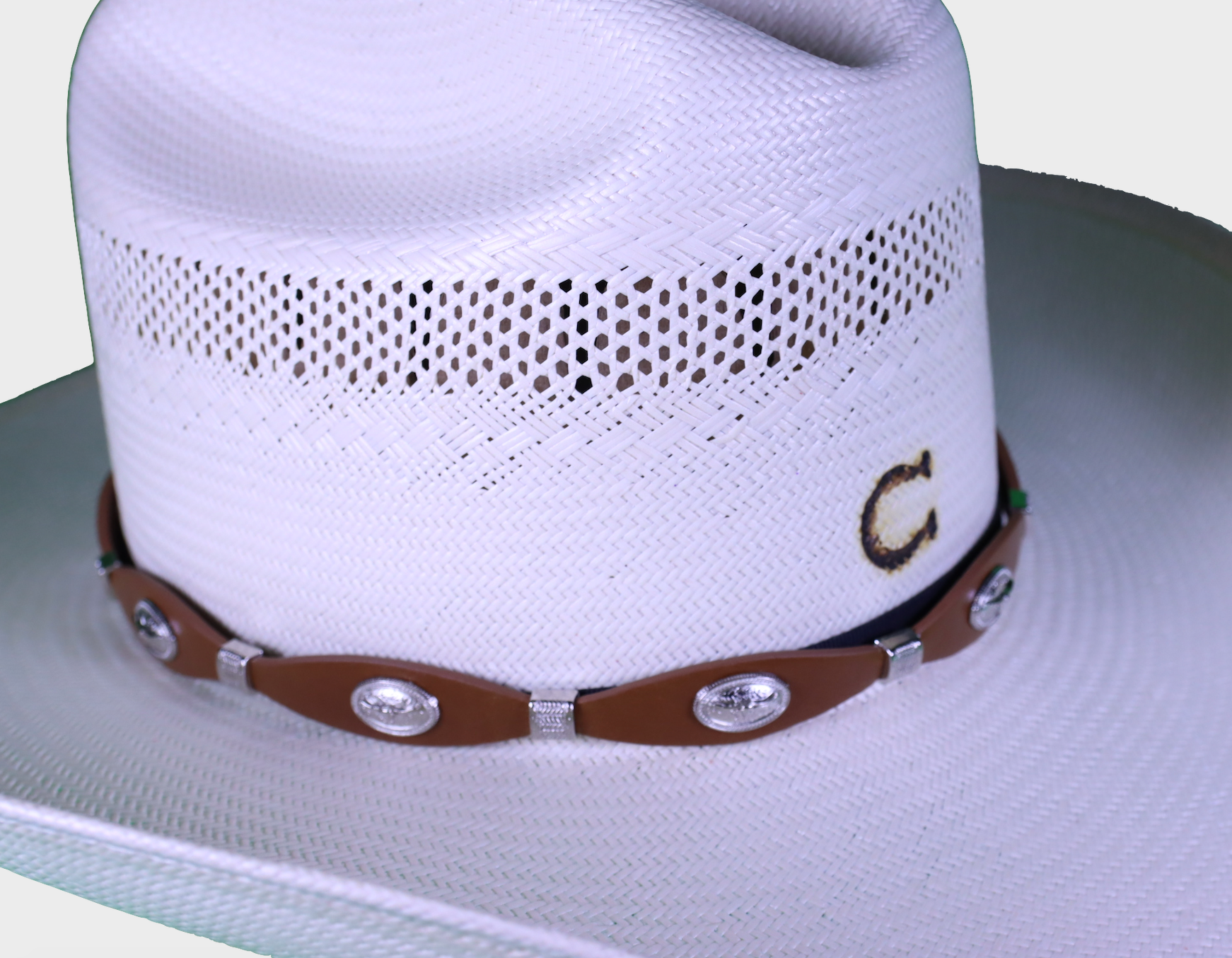 Coffee Brown leather hand band with Longhorn Conchos. View of band on straw hat. 