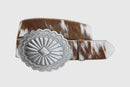 A brown and white cowhide leather belt with a silver-colored oval buckle.