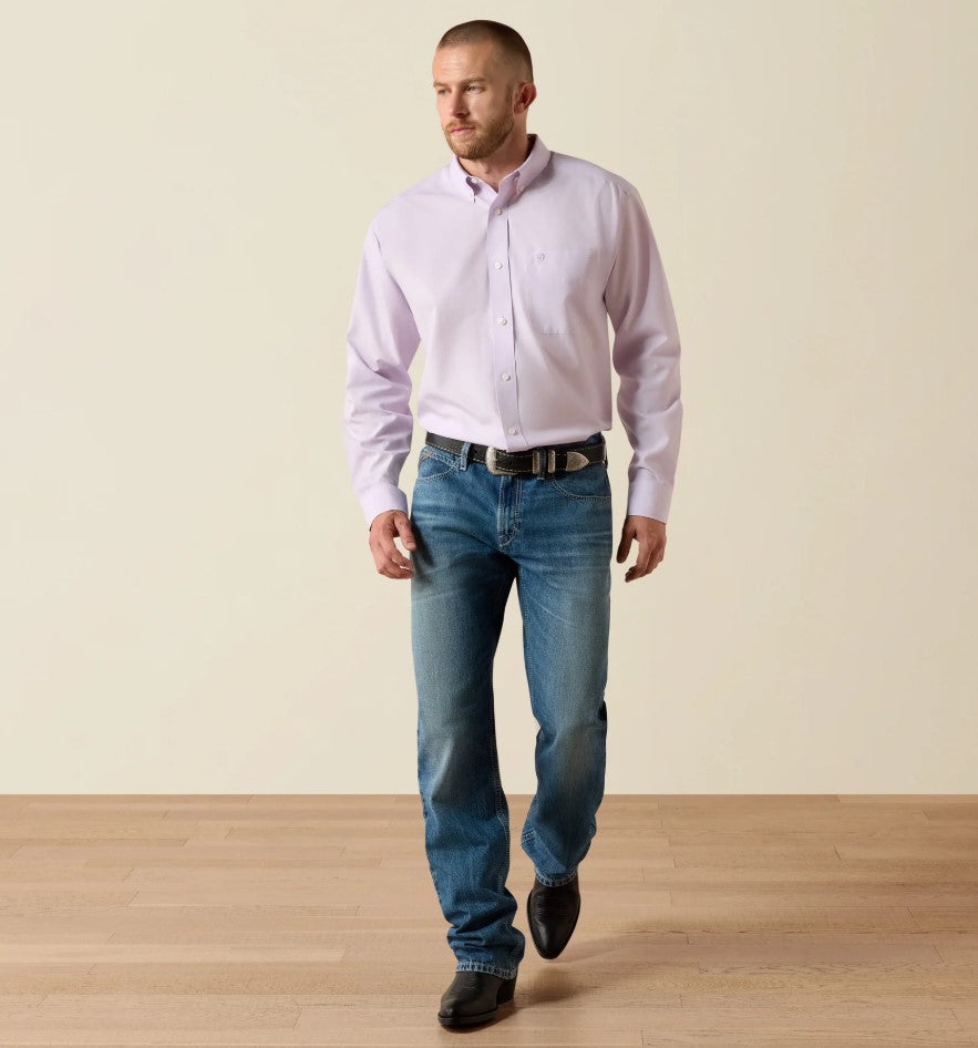 Men's Ariat long sleeve wrinkle free button closed shirt in Rhapsody, a very light purple. Full front view showing shirt tucked in on model. 