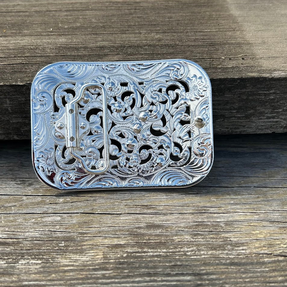 Silver buckle with intricate scroll work and iridescent rhinestones. Rear View