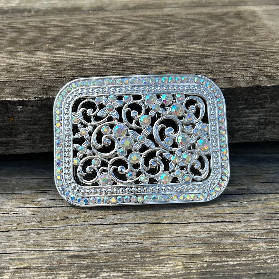 Silver buckle with intricate scroll work and iridescent rhinestones. Front View