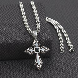 A silver-colored stainless steel chain necklace with an engraved cross pendant featuring a black stone in the center. Masculine. Front view.