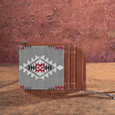 A mini zip card case with a southwestern art print, featuring a geometric pattern in grey, white, and red, combined with a grey canvas body and PU leather accents.