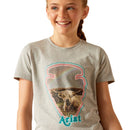 Girl's Ariat short sleeve Heather Grey T-shirt. This shirt features a graphic print on the front of a cow in the shape of arrowhead with the Ariat logo. Front view close up of graphic print. 