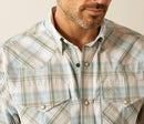 Men's Ariat long sleeve pearl snap Western Style shirt in Turquoise Plaid. Close up of collar and chest pockets left chest pocket has a stitched Ariat shield logo. 