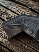 Black Alligator print leather trifold wallet with cowhide inlay and a Praying Cowboy Concho. Inside view showing cash slot and zippered pocket.