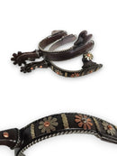 A pair of women's spurs featuring a intricate copper flower design  and a gentle 8-point rowel.