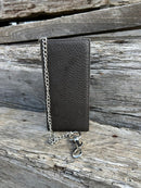Black pebbled leather tall wallet with silver chain on a swivel. Front View