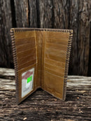 Brown leather tall wallet with whipstitch border and a embossed Praying Cowboy design. Inside view showing multiple card slots and bill slots. 