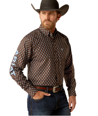 Men's Ariat long sleeve team logo shirt in brown with a blue diamond pattern. Front view showing bold team logo on sleeve.