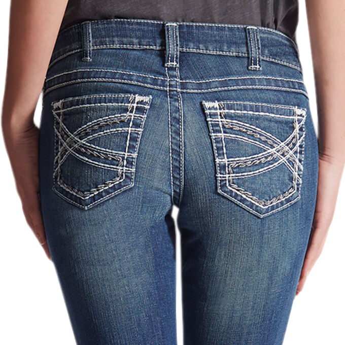 Women's Ariat mid rise boot cut jean in Marine which is a medium wash. Rear view showing stitching on pockets. 