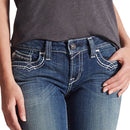 Women's Ariat mid rise boot cut jean in Marine which is a medium wash. Close up front view showing stitching details on pockets and zipper. 