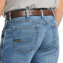 Men's Ariat Rebar M4 relaxed fit boot cut jeans in a medium wash. Rear view showing back pocket details.