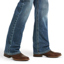 Men's Ariat M5 straight leg jean in a medium wash. Bottom view showing leg opening over jeans. 