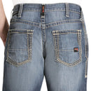 Men's Ariat FR jeans in a M4 relaxed fit boot cut. Close up rear view of back pocket stitching. 