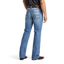 Men's Ariat M4 relaxed fit boot cut jean in a light wash. Rear view