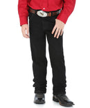 Front view of a boy wearing overdyed black Wrangler cowboy cut jeans with a five-pocket design and flat copper rivets.