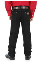 Back view of a boy wearing overdyed black Wrangler cowboy cut jeans with a five-pocket design and flat copper rivets.