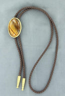 A leatherette bolo cord with an oval stone attachment and metal tips.