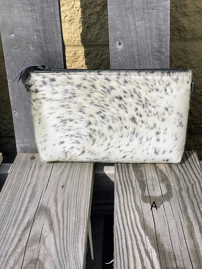 Black leather and cowhide wristlet bag that also comes with a removable adjustable crossbody strap. This is a larger wristlet with a inside zip close pocket and credit card slots. Front View A