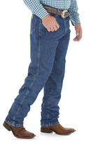 A side view of a man wearing Wrangler men's George Strait Cowboy Cut relaxed fit jeans with a high-rise waist and a straight leg.
