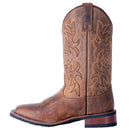 A instep side view of a women's Laredo 5602 11 inch tan leather boot with a square toe and floral embossing on the shaft.