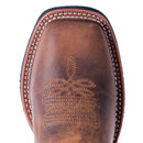 A toe profile view of a women's Laredo 5602 11 inch tan leather boot with a square toe and floral embossing on the shaft.