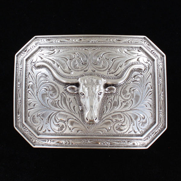  This is a silver tone rectangle buckle with a stylish smooth edge. It features a centered longhorn motif on a western scroll engraving.