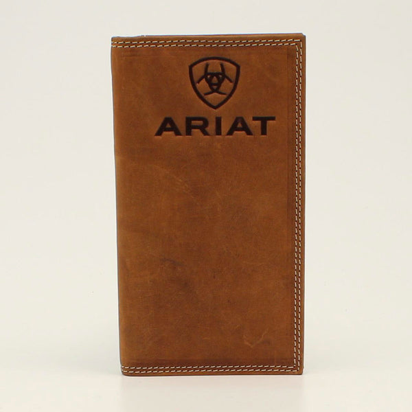 A tall brown leather wallet with the Ariat logo embossed on the front. The wallet features a shield-like design in the upper center. Front view.